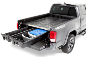 Pickup truck bed with sliding storage drawer