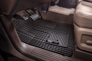 Black rubber car floor mat in driver's footwell