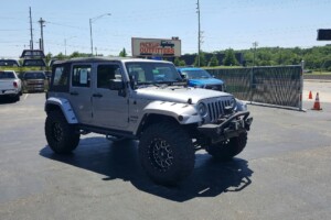 Jeep wrangler with lift kit, wheels, tires and front bumper with a winch